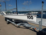 Official Melges 19 combi-trailer and detachable dolly, front quarter view. Boat and rig shown for context and not included.