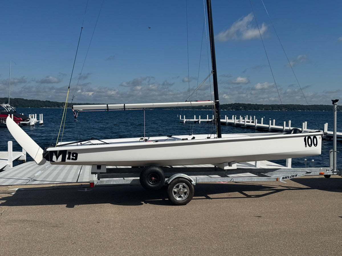 Official Melges 19 combi-trailer and detachable dolly, side view. Boat and rig shown for context and not included.